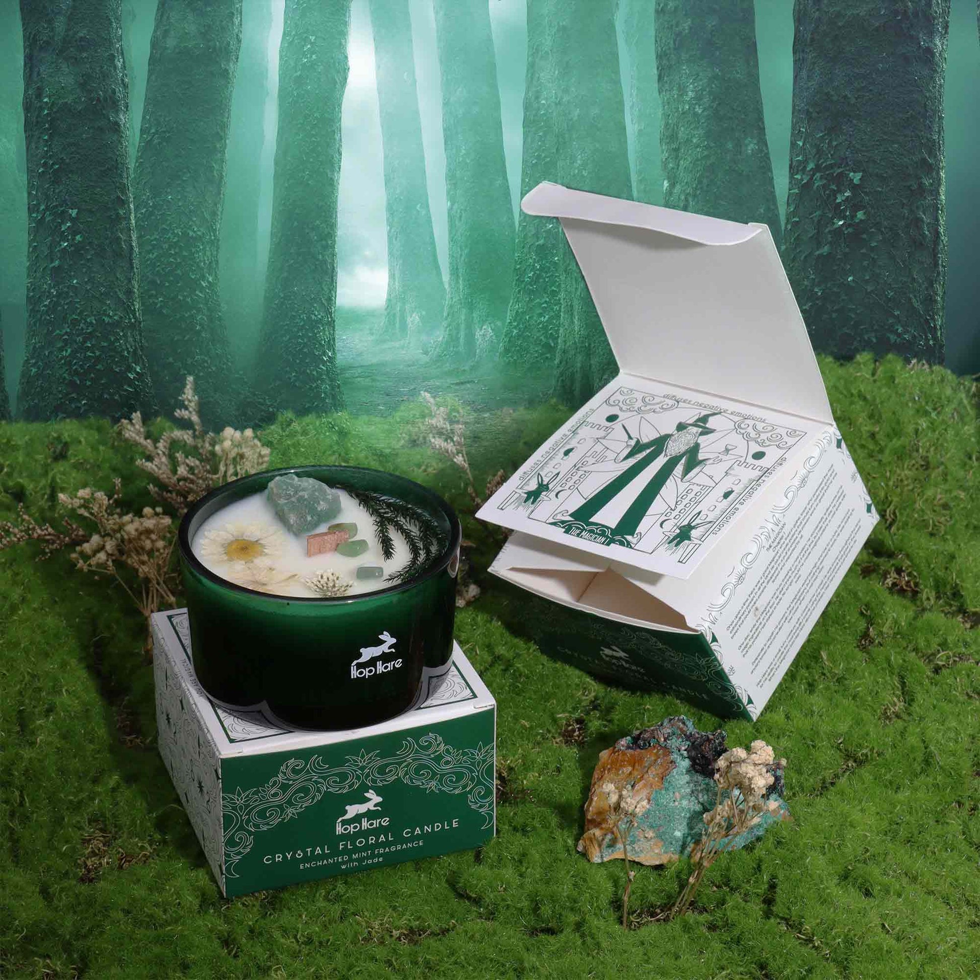 Hop Hare The Magician crystal candle with jade, dried flowers, and tarot card in dark green jar
