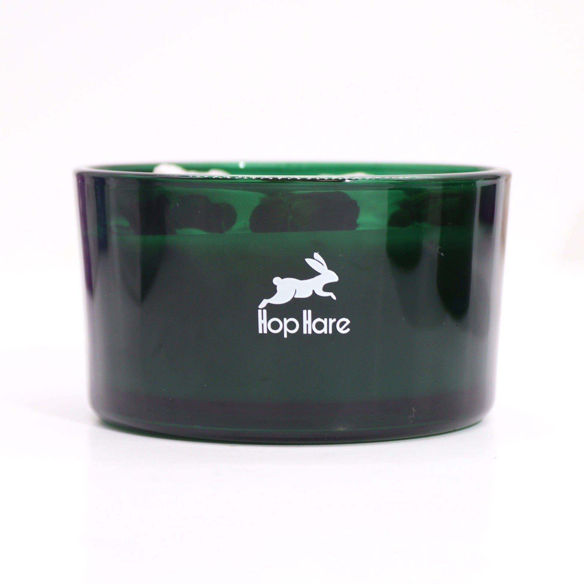 Hop Hare The Magician crystal candle with jade, dried flowers, and tarot card in dark green jar
