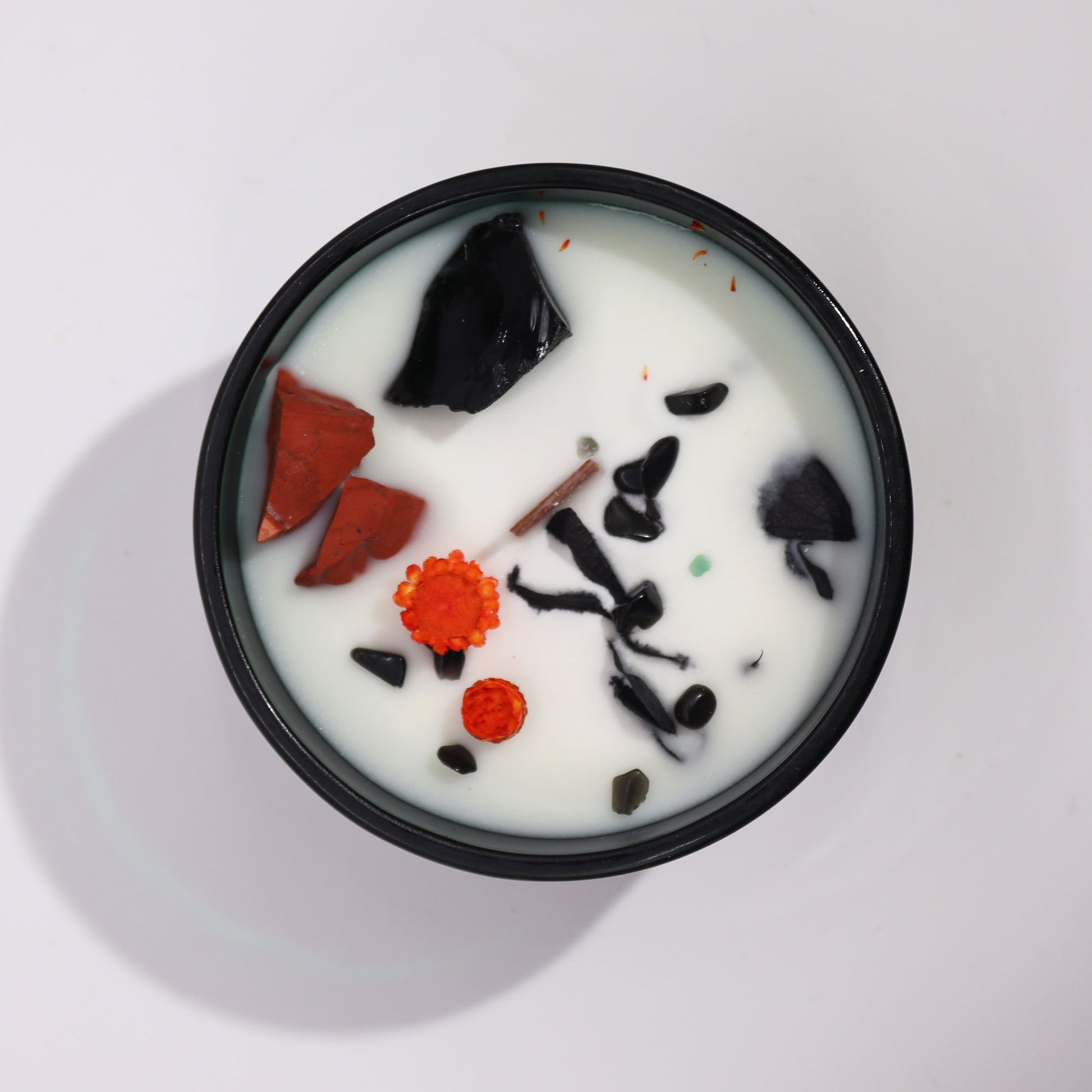 Hop Hare The Devil crystal candle with red jasper, black agate, dried flowers, and tarot card in dark green jar
