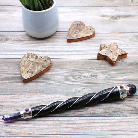 Twisted wooden wand with silver plated copper wire, amethyst point and sphere, and gemstones. Perfect for spiritual healing, intuition, and energy work.
