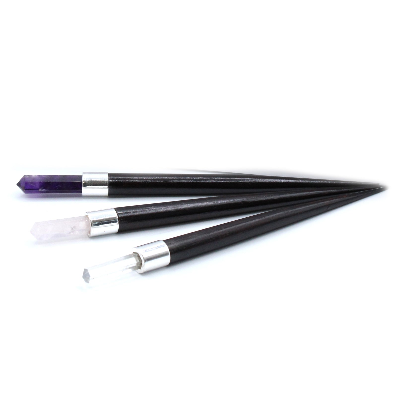 Set of 3 healing wands with pointed crystal tips: amethyst, rose quartz, and rock quartz. Featuring wooden handles and silver caps for energy work and meditation.

