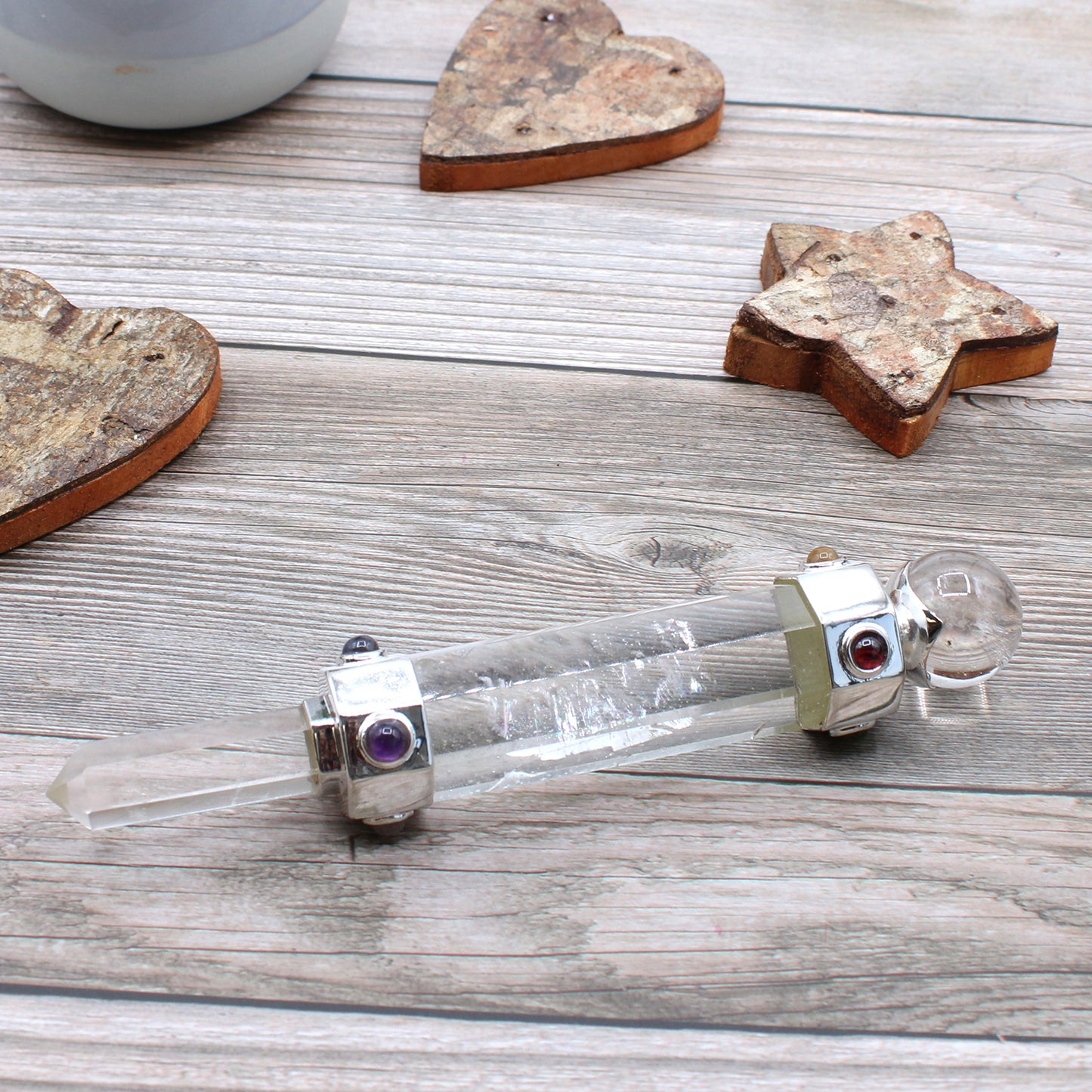 Hexagonal rock quartz healing wand with pointed tip, rounded sphere end, and gemstone accents. Ideal for energy amplification, clarity, and chakra work.
