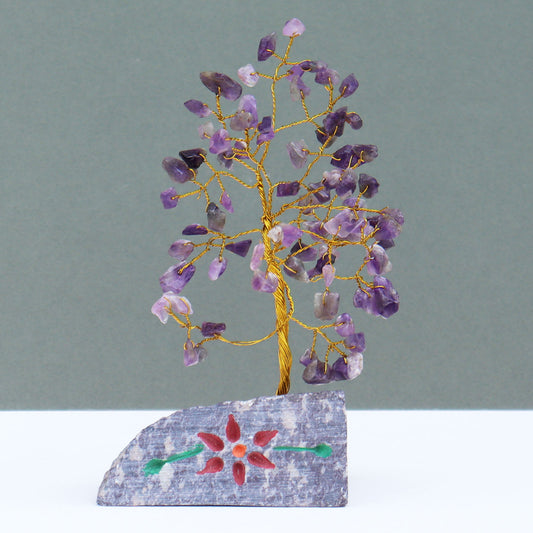 Amethyst crystal tree with 80 violet gemstone chips on wire branches, fixed into a detailed hand-carved and painted stone base crafted by artisans in India.

