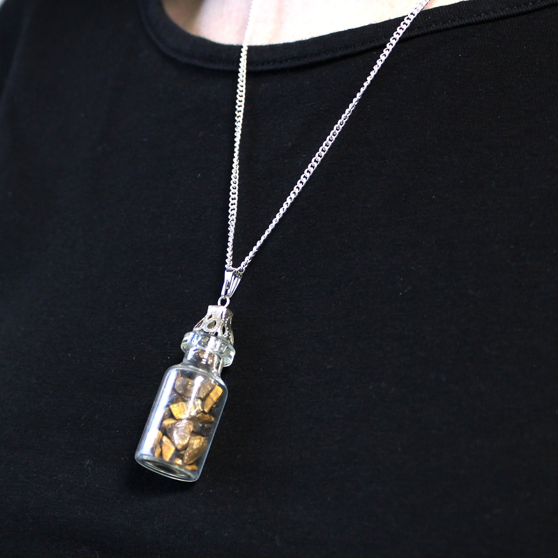 "Mini glass bottle necklace filled with golden-brown tiger’s eye chips, on a silver-plated chain"

