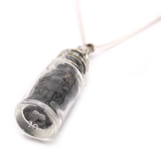 "Mini bottle necklace filled with black onyx chips, hanging from a silver-plated chain"

