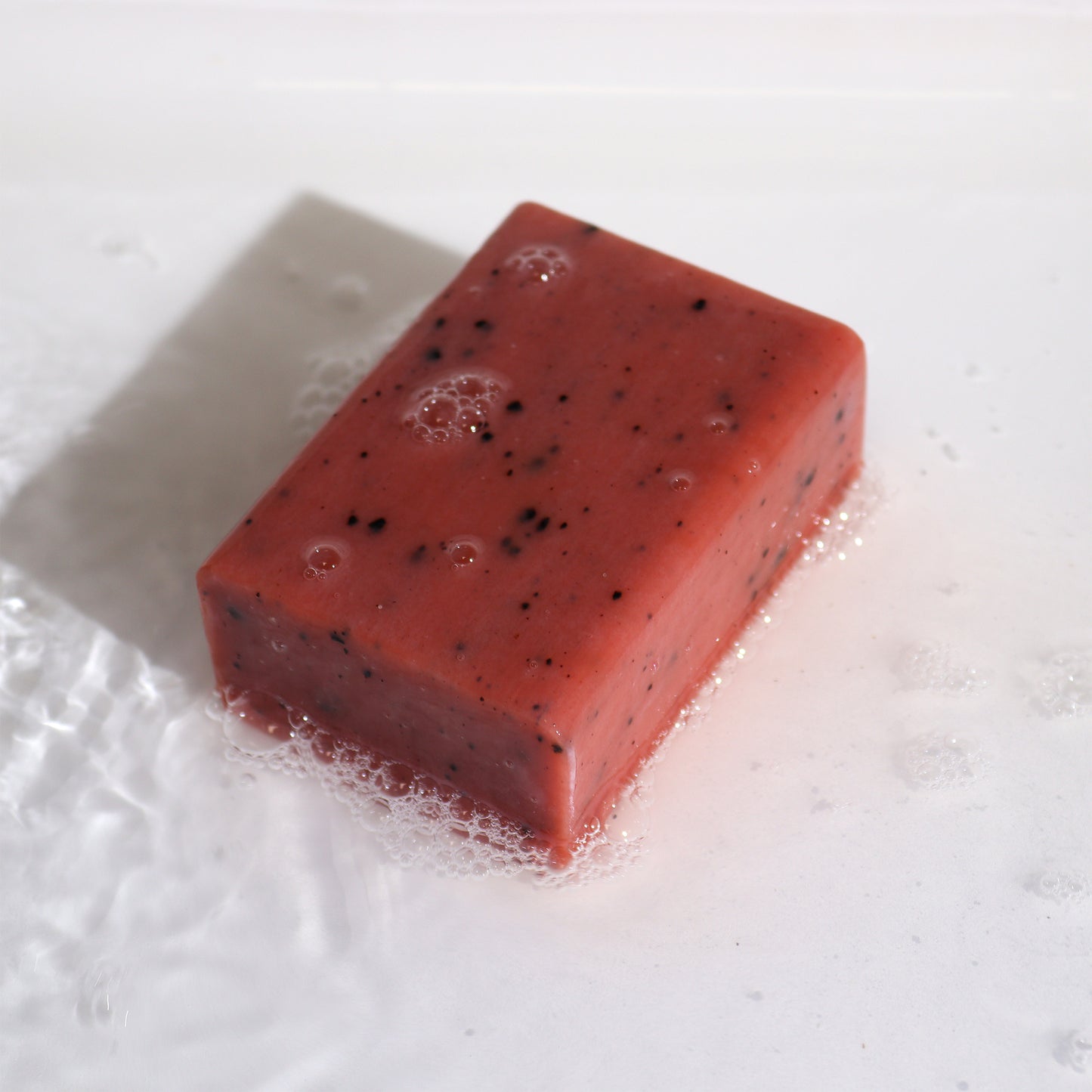 Natural clay soap bar with orange, ginger, yellow clay, and coffee – exfoliating and energising skincare.

