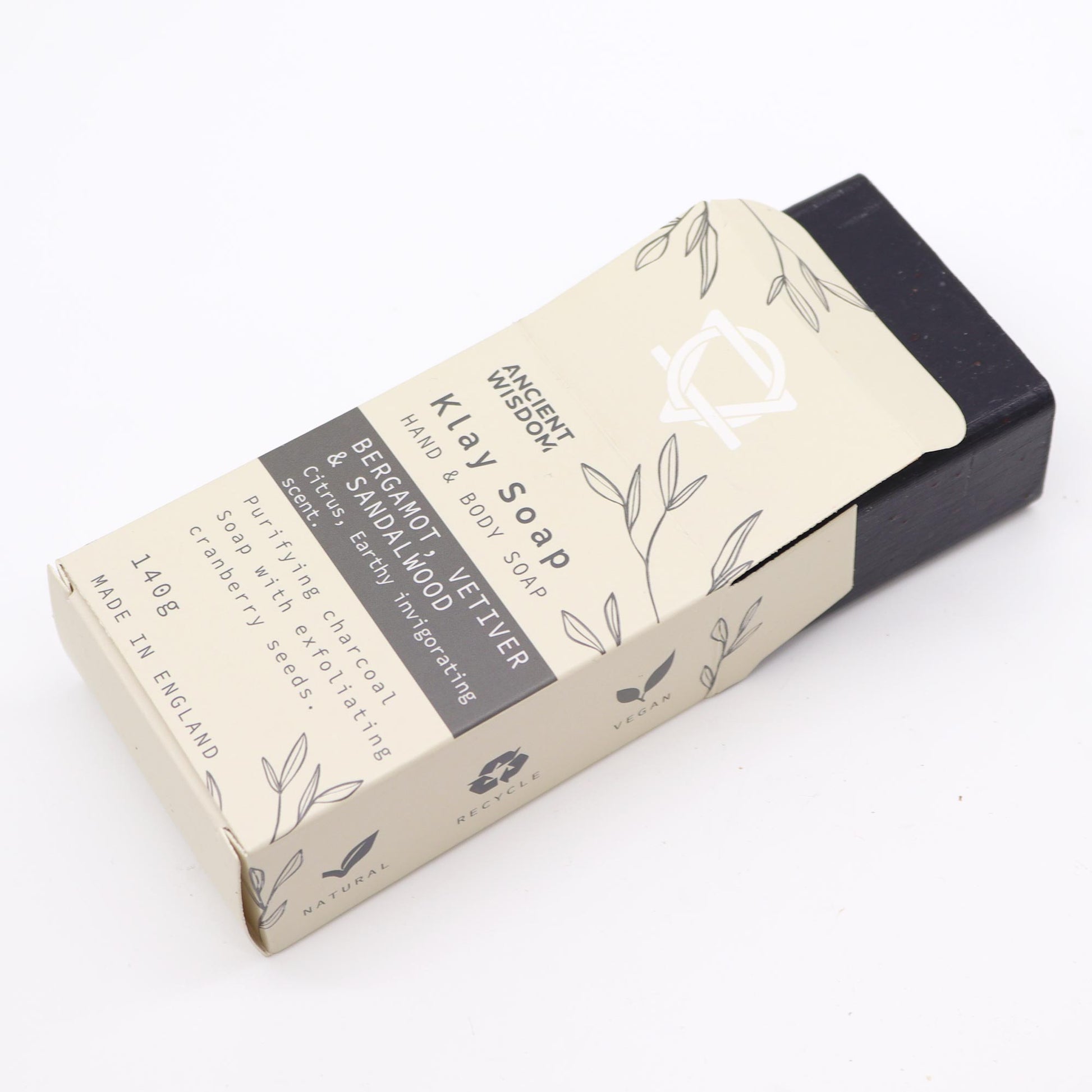 Natural clay soap bar with charcoal, cranberry seeds & sandalwood – detoxifying, exfoliating, and handmade in the UK.

