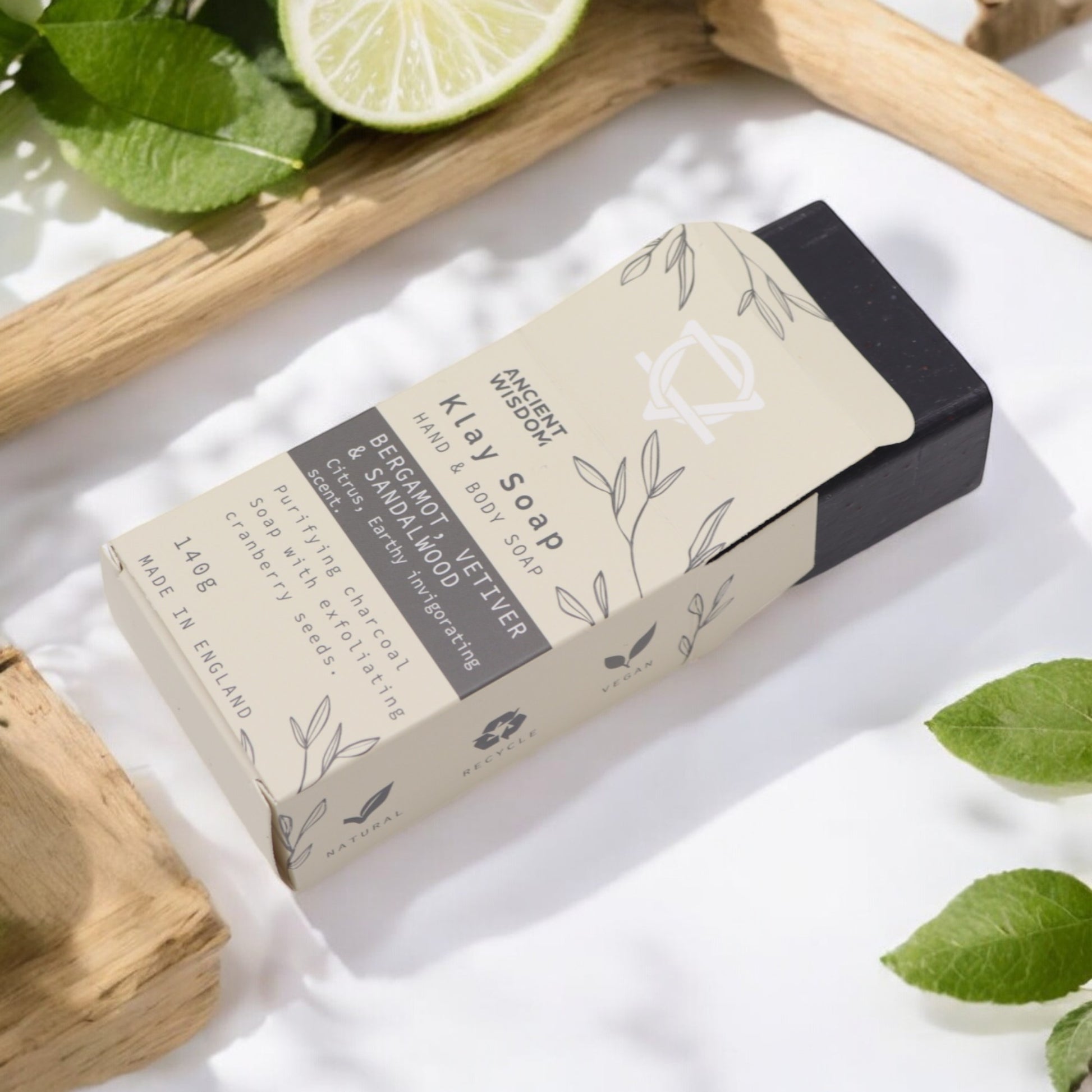 Natural clay soap bar with charcoal, cranberry seeds & sandalwood – detoxifying, exfoliating, and handmade in the UK.

