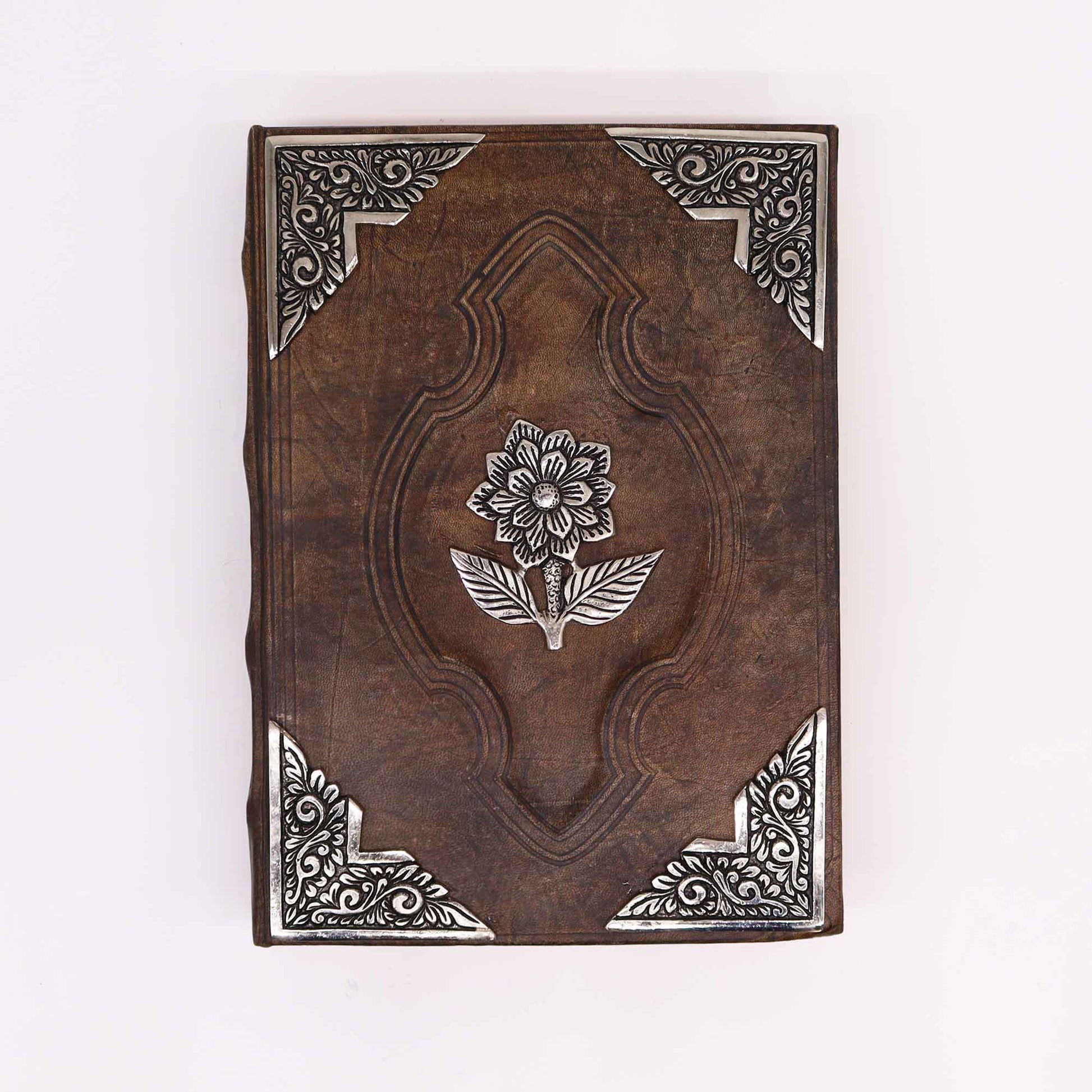 Leatherbound journal with zinc rose emblem and ornate metal corner designs

