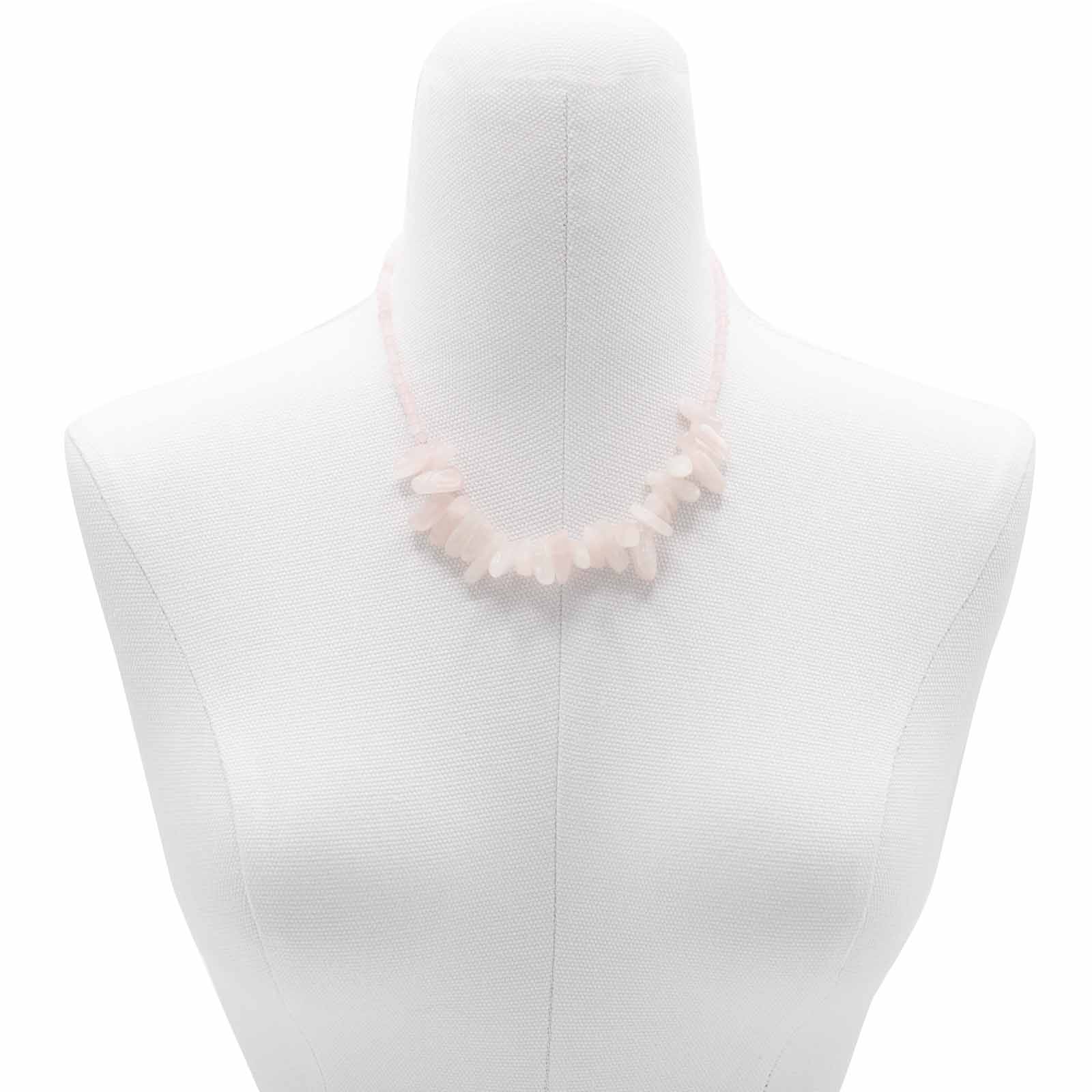 "Longstone Gem Necklace with rose quartz gemstone chips and round beads in soft blushing pink, displayed on a jewellery bust."