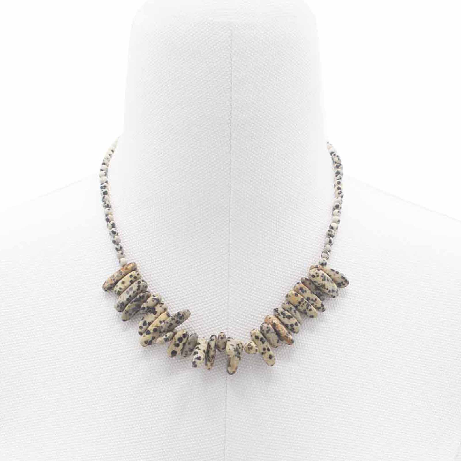 "Longstone Gem Necklace with Dalmatian Stone gemstone chips and round beads featuring natural black spots on a cream base, styled on a white display stand."