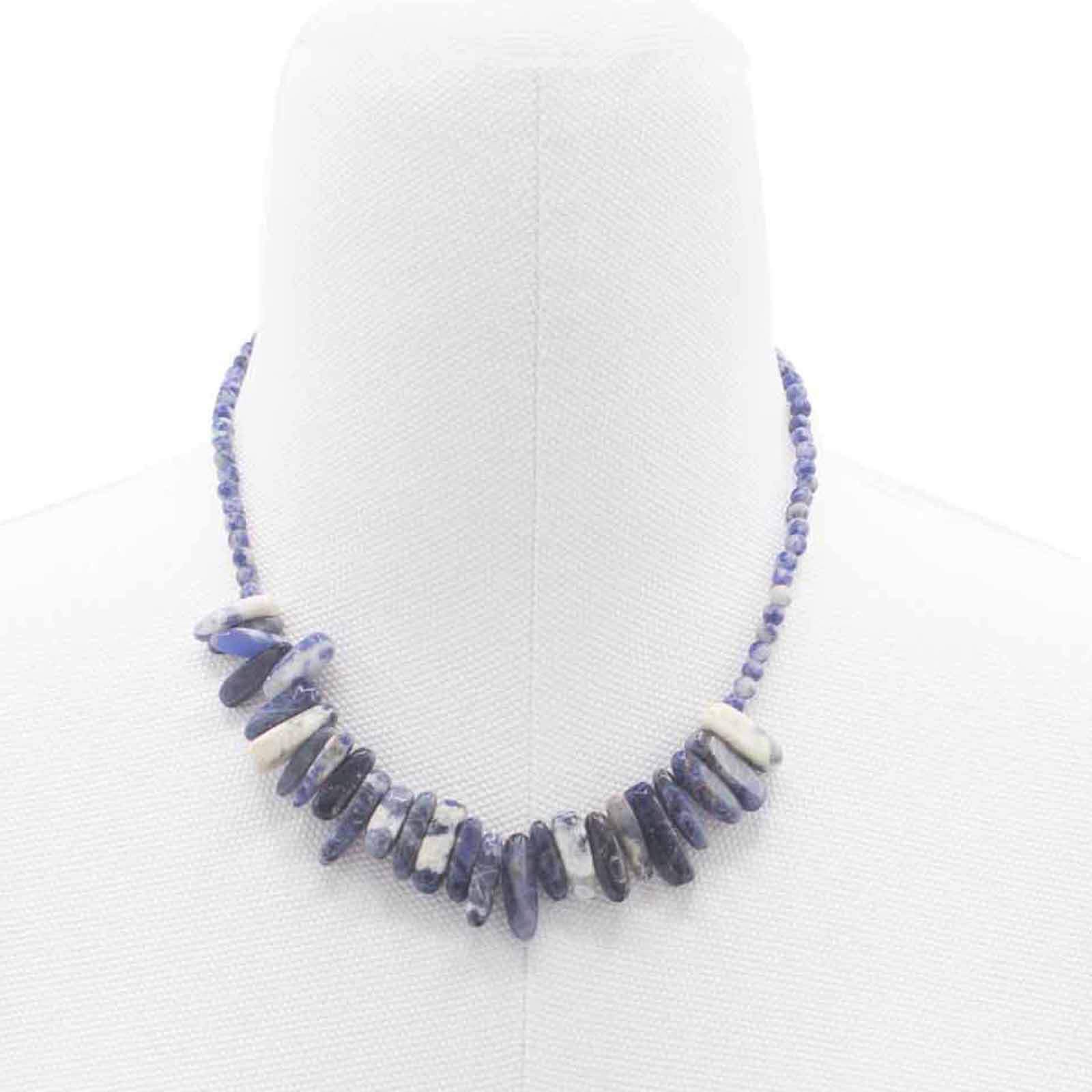 "Longstone Gem Necklace featuring deep blue sodalite gemstone chips and matching round beads, displayed on a white bust."
