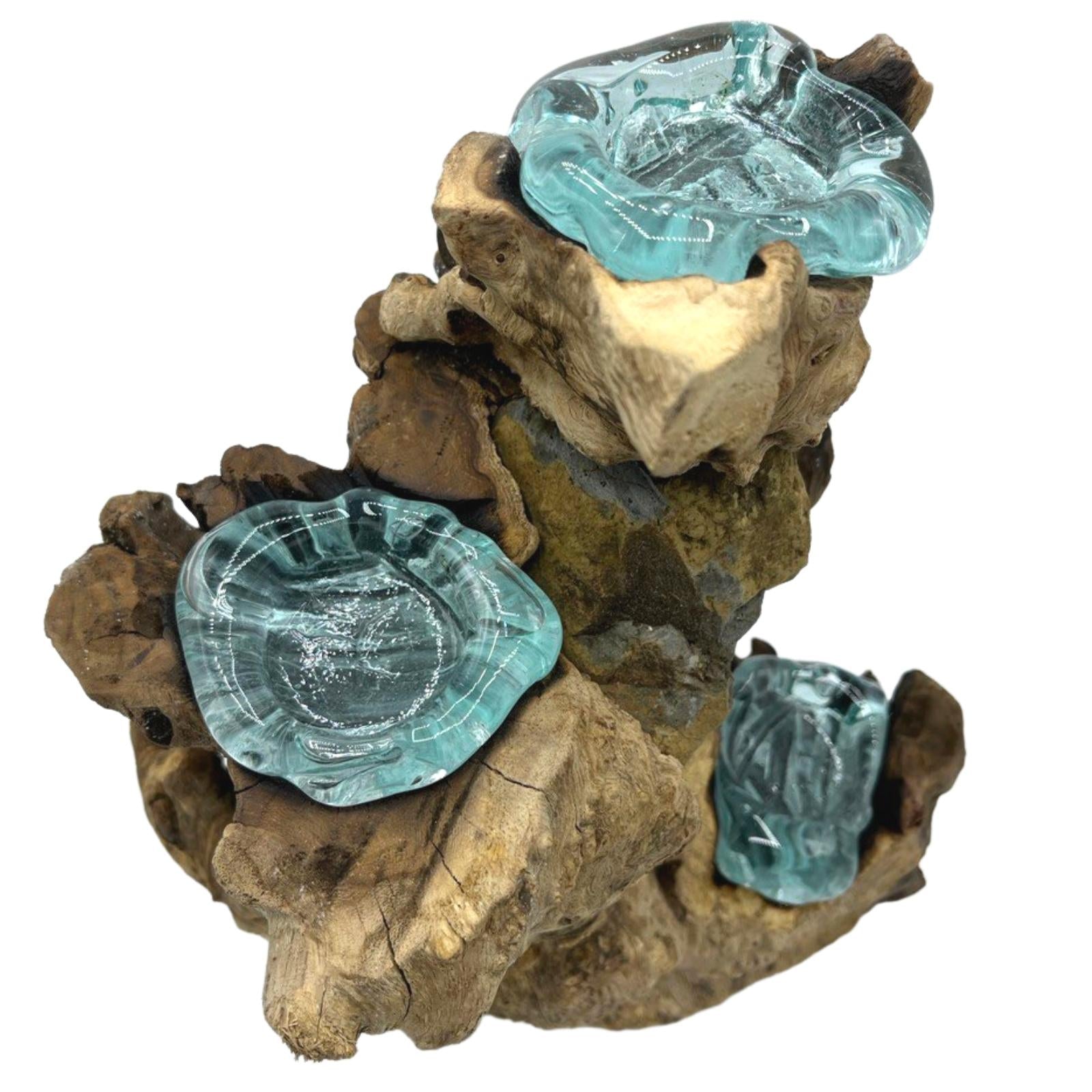 Molten glass and wood three candle holder with hand-poured tealight vessels resting on natural Balinese Gamal wood.
