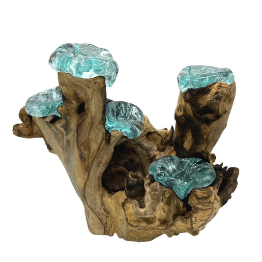 Molten glass and wood five candle holder with hand-blown tealight vessels on natural Balinese wood.