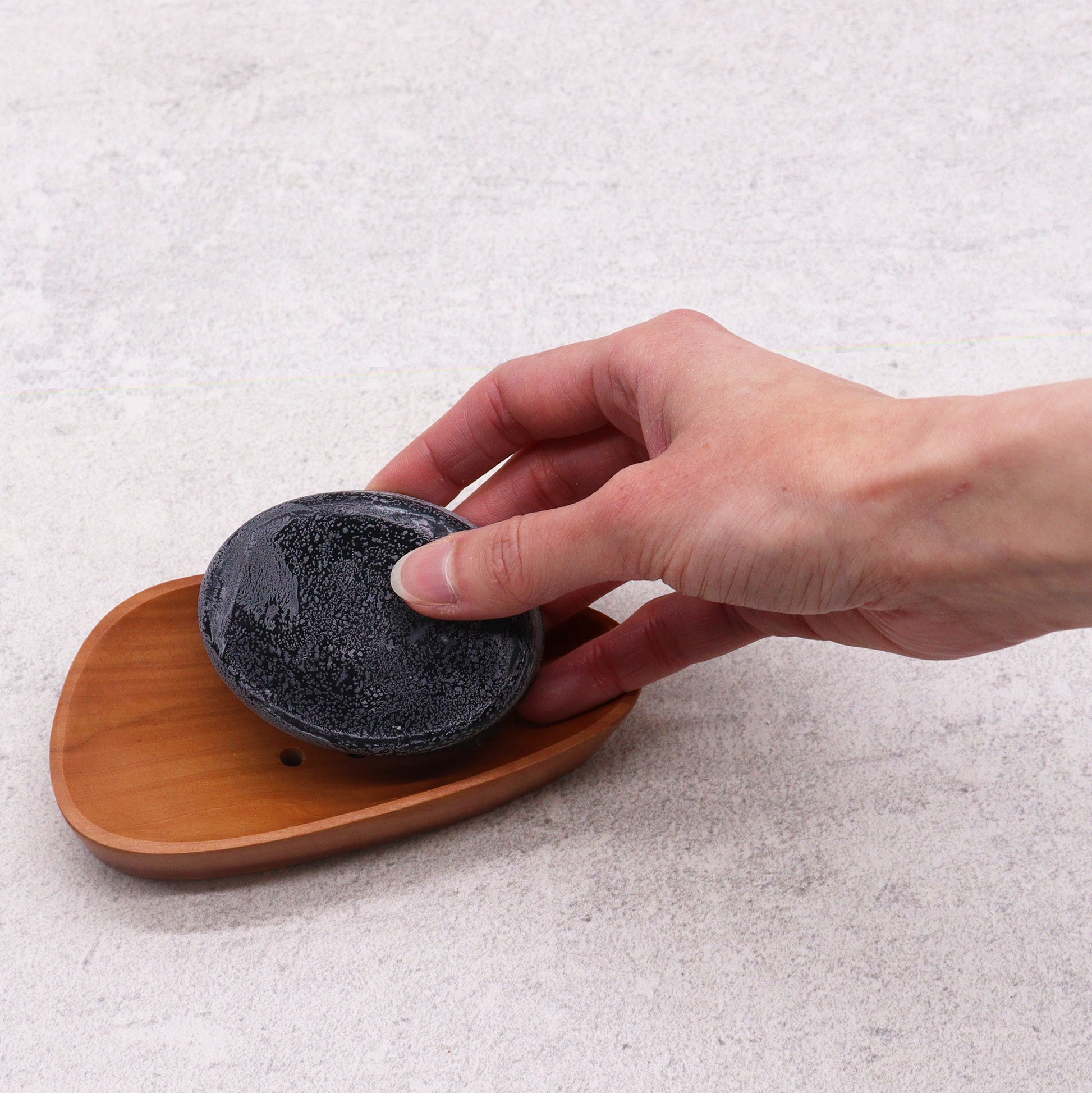 Pebble shaped mahogany soap dish with drainage holes

