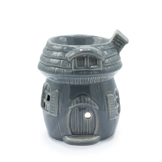 Grey ceramic oil burner shaped like a mushroom house with detailed windows, door, and roof, designed for essential oils and tealights

