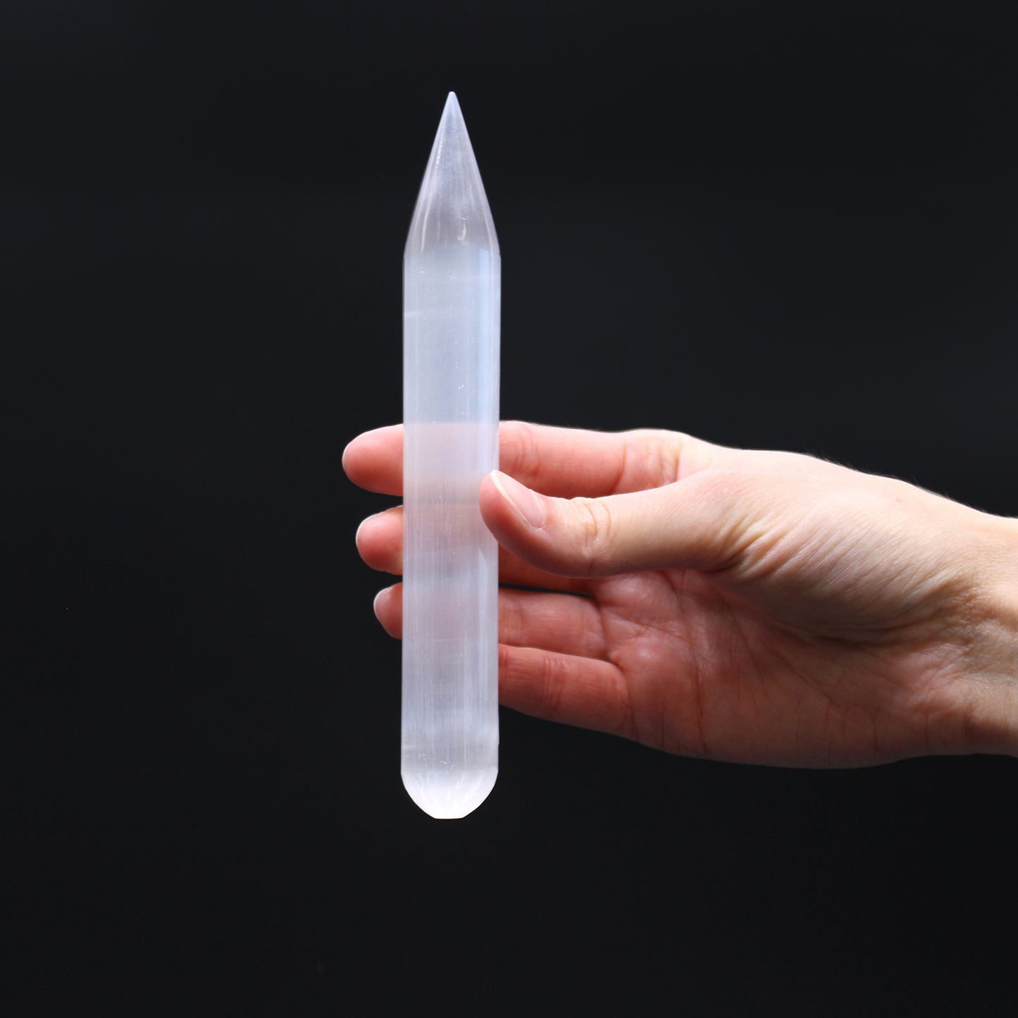 Polished Selenite wand with single pointed tip and rounded base, hand-carved from Moroccan crystal for spiritual cleansing, chakra work, and energy alignment.

