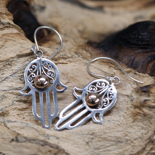 "Hamsa hand earrings in sterling silver with filigree detail and central 18k gold accent, handcrafted in Indonesia."