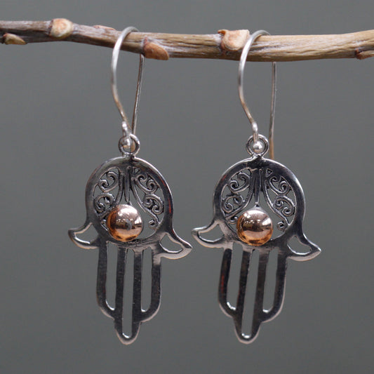 "Hamsa hand earrings in sterling silver with filigree detail and central 18k gold accent, handcrafted in Indonesia."