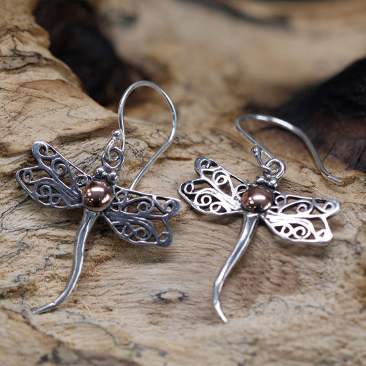 "Dragonfly-shaped sterling silver earrings with filigree wings and 18k gold body detail, handcrafted in Indonesia."