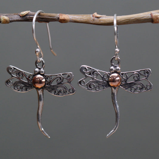 "Dragonfly-shaped sterling silver earrings with filigree wings and 18k gold body detail, handcrafted in Indonesia."