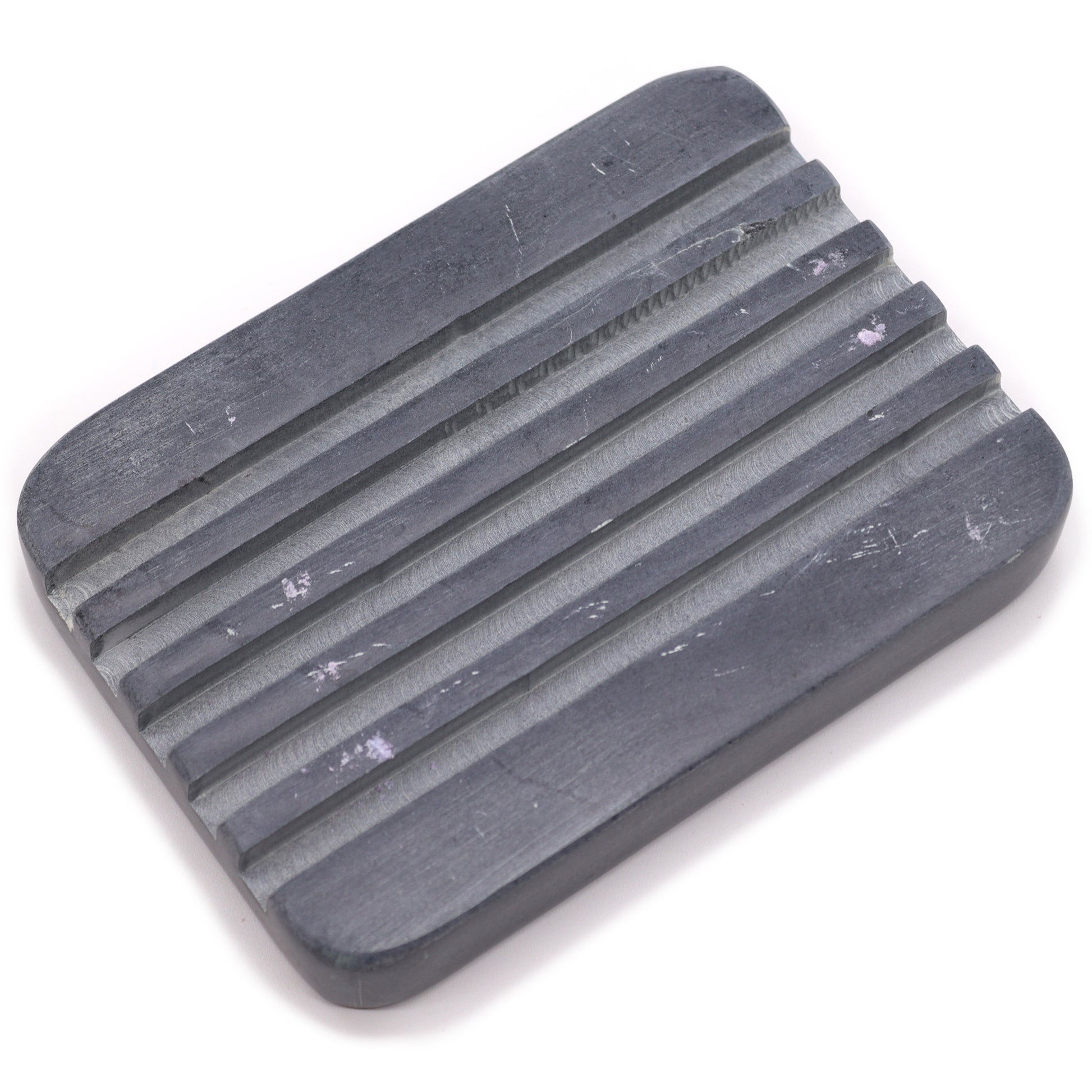 Rectangular grey soapstone soap dish with drainage grooves.

