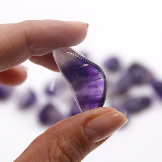 Grade A Amethyst Banded tumbled stones (10–25 mm), polished with natural banding for serenity and spiritual clarity. Sold in a 24-piece bag.

