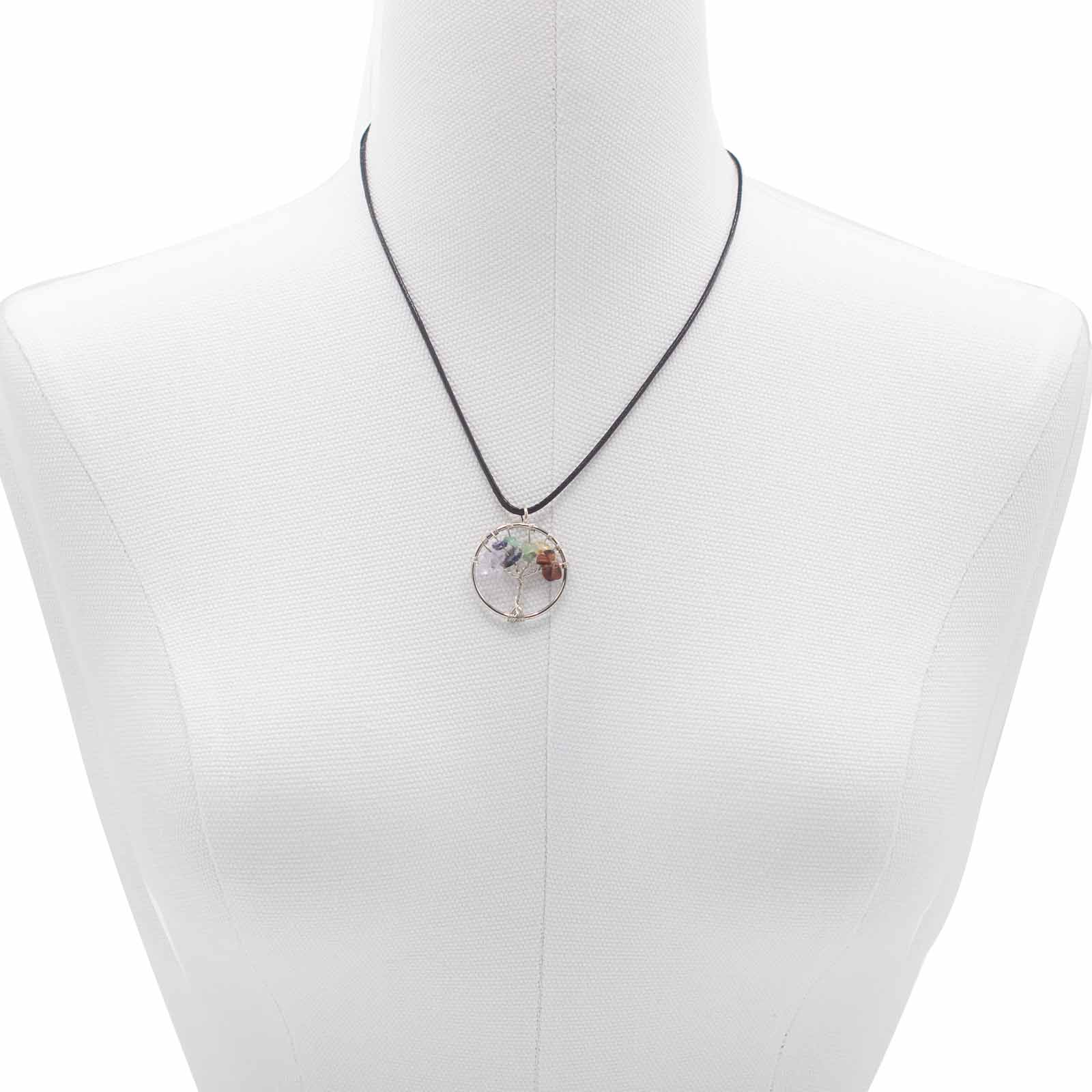 "Tree of Life Pendant featuring seven Chakra gemstones arranged in a rainbow design, crafted with silver wire on a black cord."

