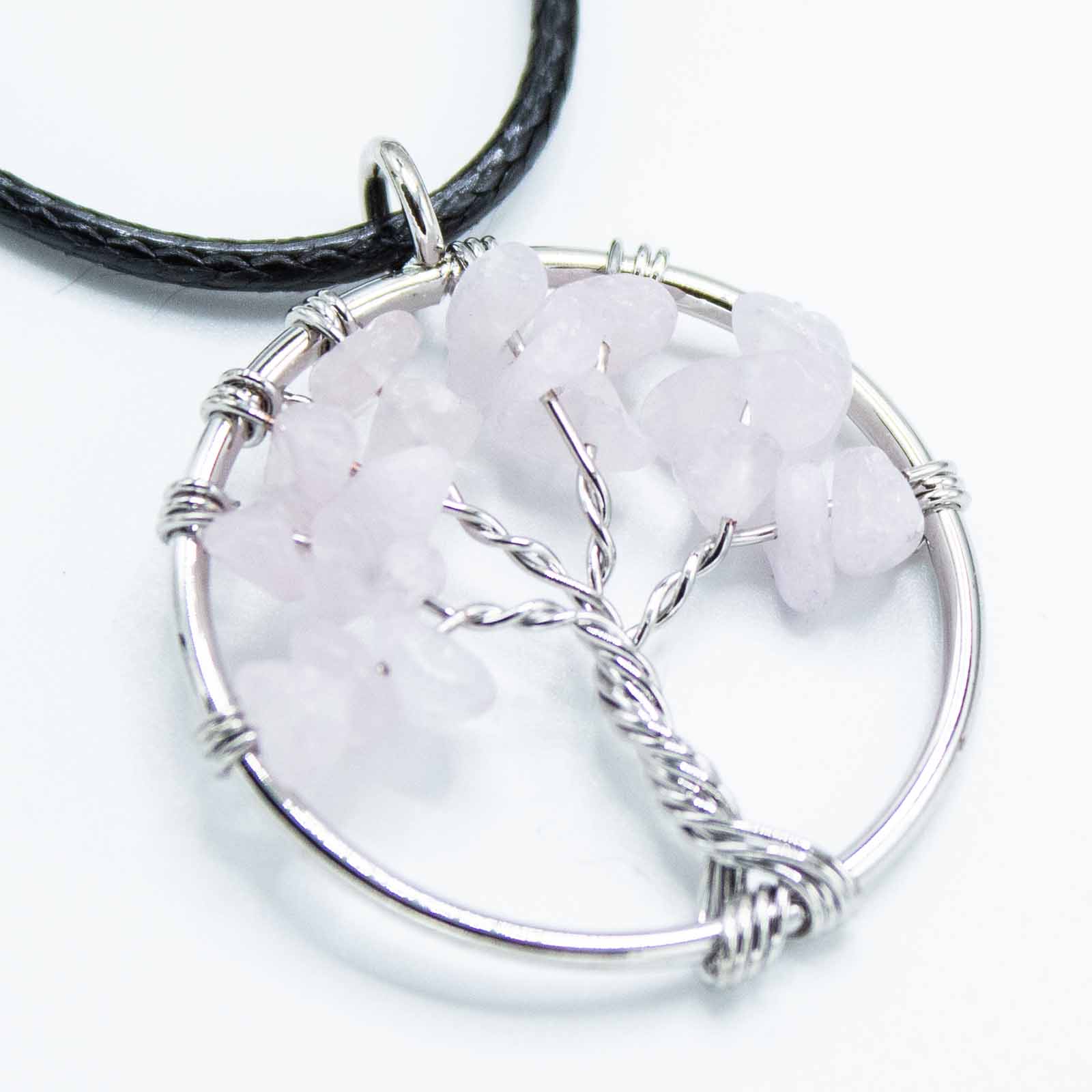 "Tree of Life Pendant with soft pink Rose Quartz gemstone, delicately wire-wrapped in silver and suspended on a black cord necklace."

