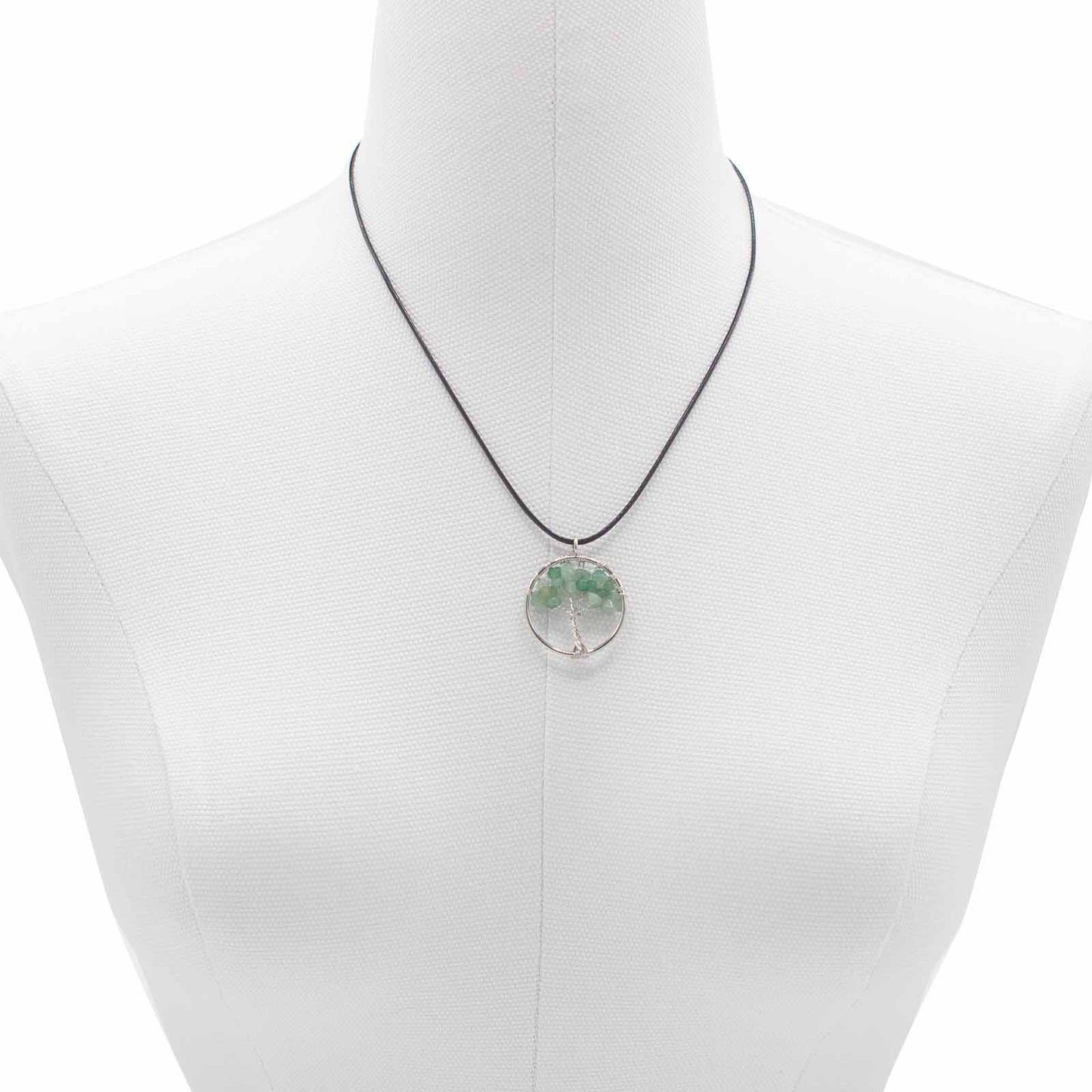 "Tree of Life Pendant with soothing green Jade gemstone and silver wire-wrapped design, hanging on a black cord."

