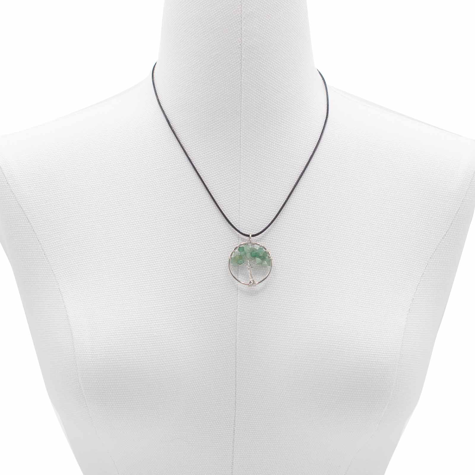 "Tree of Life Pendant with soothing green Jade gemstone and silver wire-wrapped design, hanging on a black cord."

