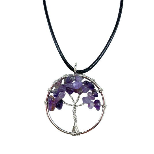 "Tree of Life Pendant featuring a natural Amethyst gemstone in a silver wire-wrapped design, suspended on a black cord."

