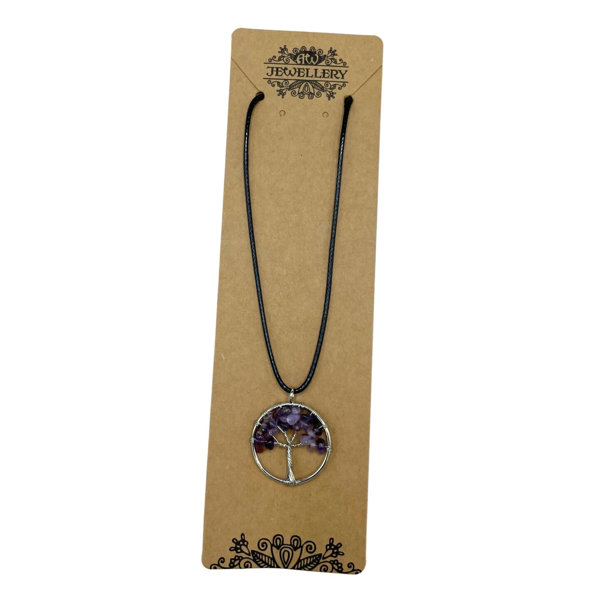 "Tree of Life Pendant featuring a natural Amethyst gemstone in a silver wire-wrapped design, suspended on a black cord."

