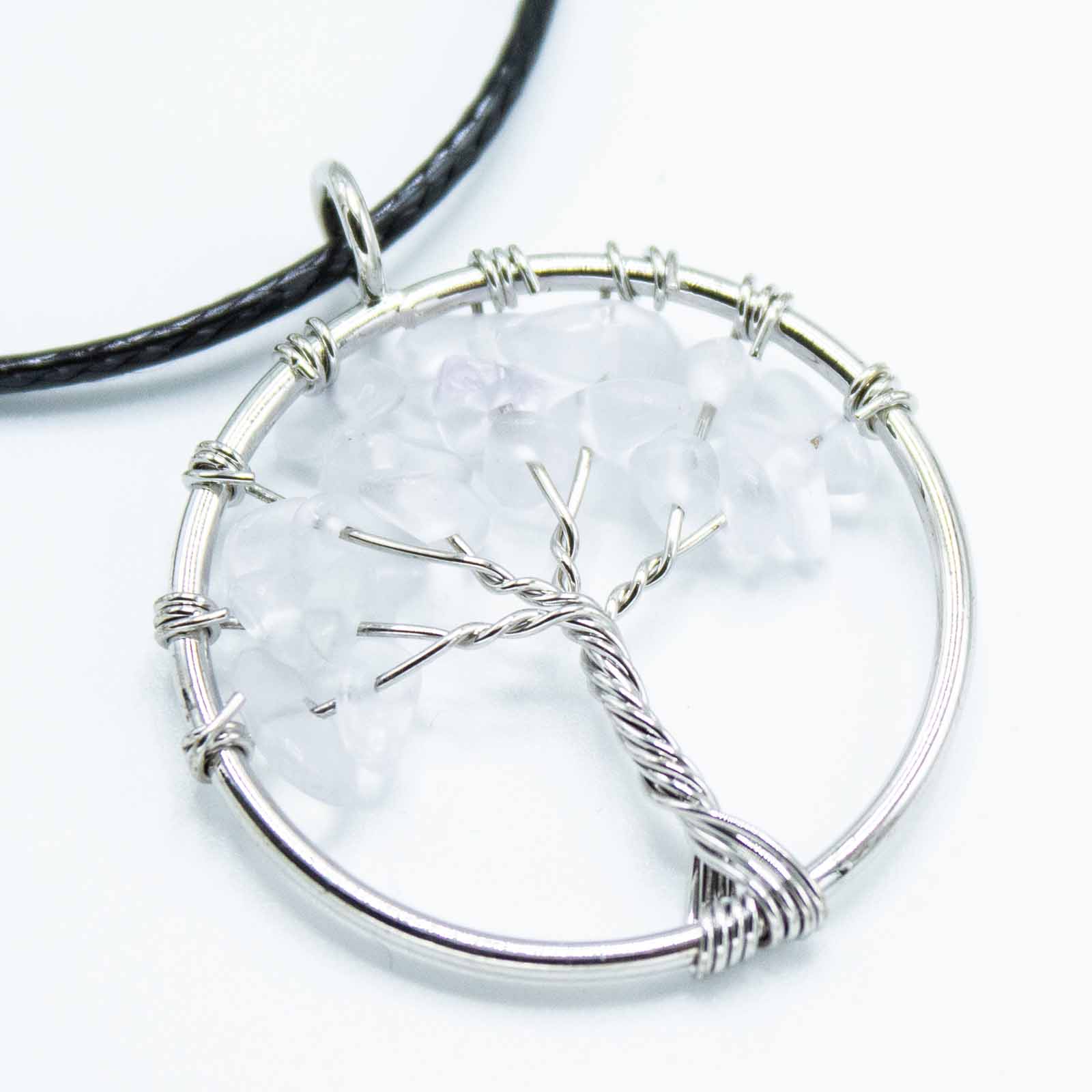 "Tree of Life Pendant with clear Rock Crystal gemstone, silver wire-wrapped design on a black cord necklace."

