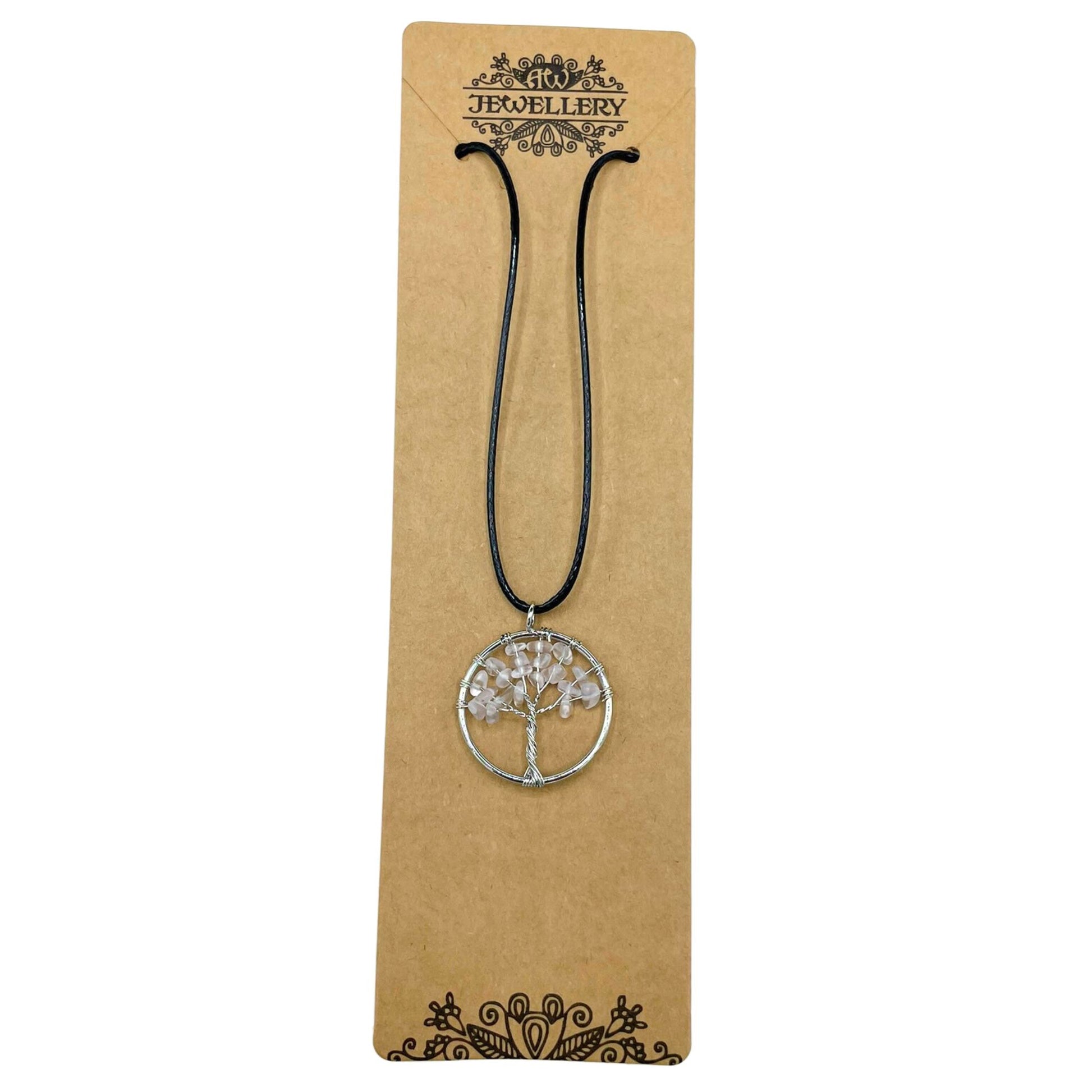 "Tree of Life Pendant with clear Rock Crystal gemstone, silver wire-wrapped design on a black cord necklace."

