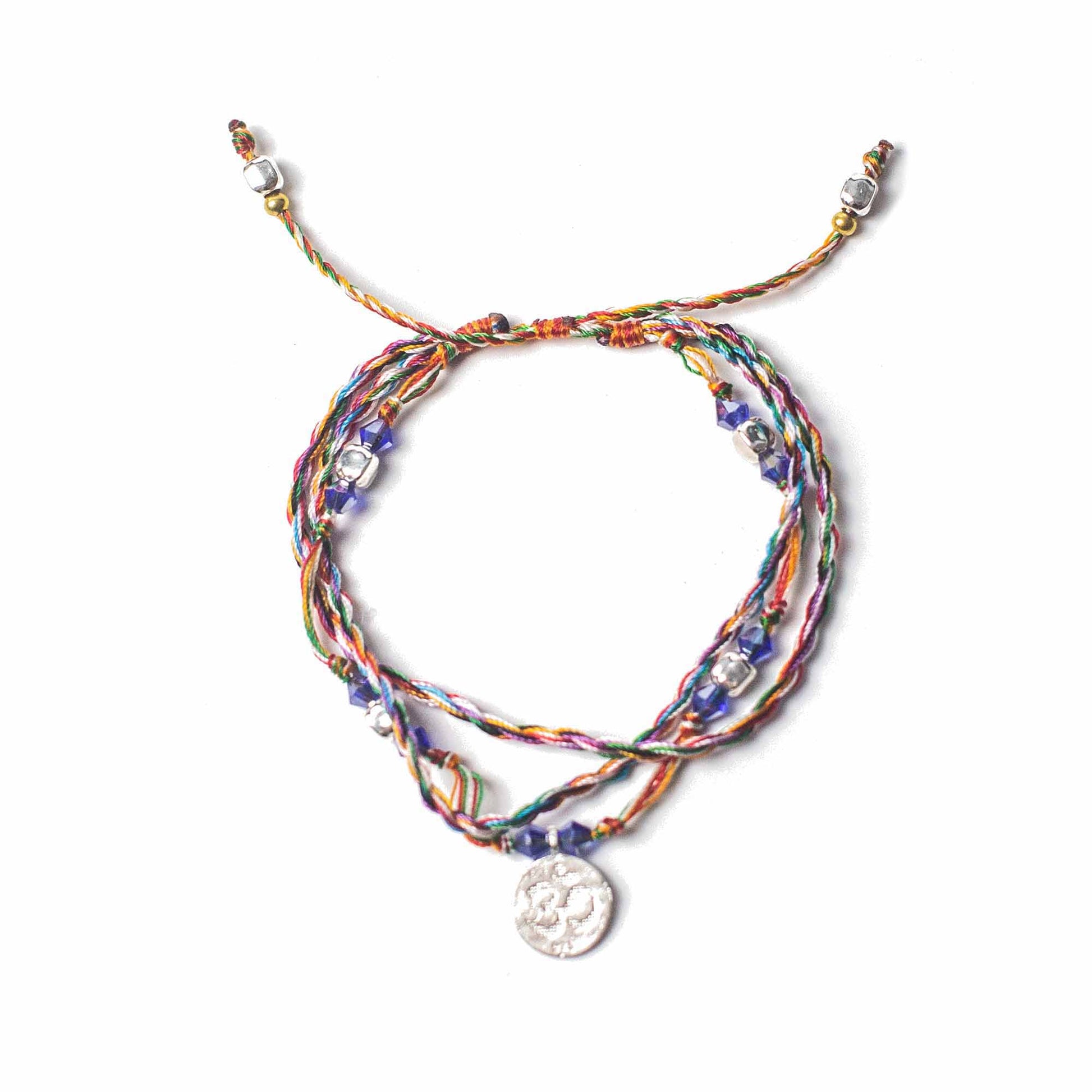 Multi-coloured Temple String Bracelet with silver Om charm symbolizing serenity, mindfulness, and presence.

