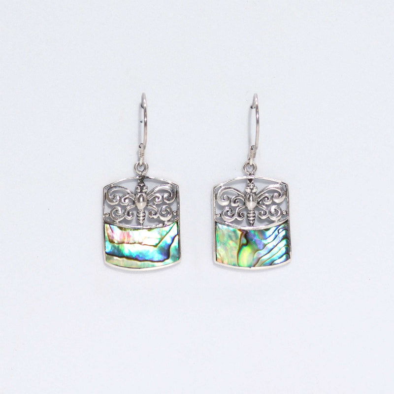Handmade sterling silver earrings with dragonfly filigree and iridescent abalone shell inlay, displayed on a white background