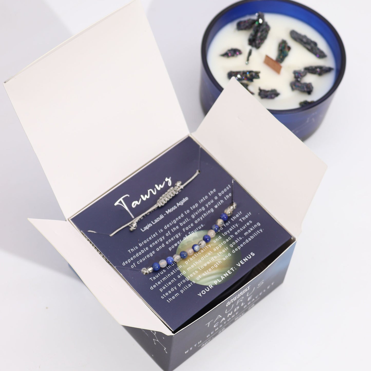 Taurus Zodiac Crystal Candle with gemstone bracelet, midnight blue jar with constellation and earthy crystal accents
